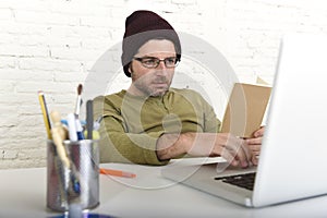 Young attractive hipster businessman working from his home office as freelancer self employed business model
