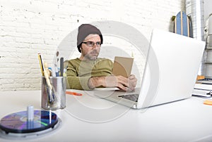 Young attractive hipster businessman working from his home office as freelancer self employed business model