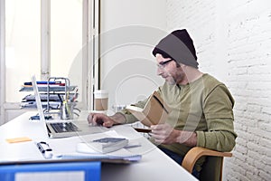 Young attractive hipster businessman working from his home office as freelancer self employed business model