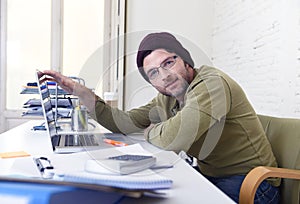 Young attractive hipster businessman working from his home office as freelancer self employed business model