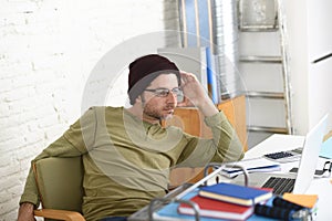 Young attractive hipster businessman working from his home office as freelancer self employed business model