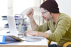 Young attractive hipster businessman working from home office as freelancer self employed business model