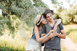 Young attractive hipster couple hugging at the forest