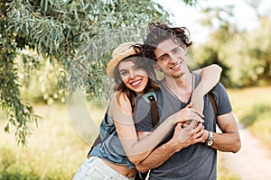 Young attractive hipster couple hugging at the forest