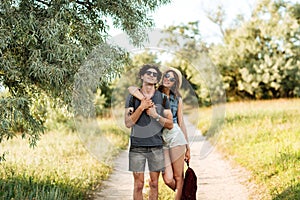 Young attractive hipster couple hugging at the forest