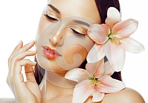 Young attractive lady close up with hands on face isolated flower lily brunette spa