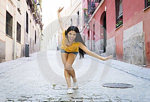 Young attractive latin woman happy and excited posing on modern urban European city