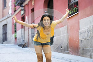 Young attractive latin woman happy and excited posing on modern urban European city