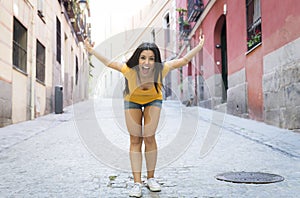 Young attractive latin woman happy and excited posing on modern urban European city