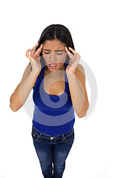 Young attractive latin woman holding her head in stress suffering headache and migraine