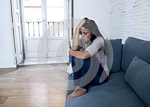 young attractive latin woman lying at home couch worried sufferi