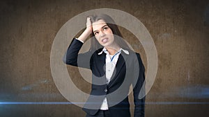 Young attractive longhair businesswoman in suit stressed and holding her head in fatigue, studio background