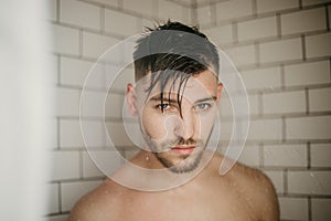 Young Attractive Male Model Washing Hair in Trendy Modern Subway Tile Wet Shower