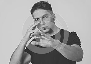 Young attractive man with an angry face in boxing stance ready to fight