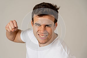 Young attractive man angry and furious in boxing stance ready to fight