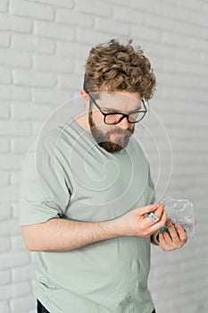 Young attractive man assembles furniture - handwerker and interior objects concept