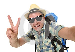 Young attractive man or backpacker student taking selfie photo with mobile phone or camera