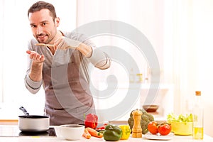 Young attractive man cooking in a kitchen