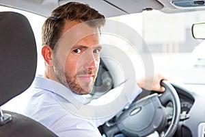 Young attractive man driving his car