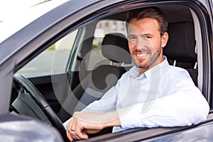 Young attractive man driving his car