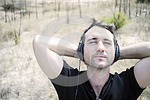 Young attractive man enjoying music on his headphones