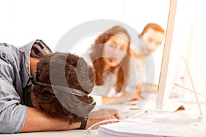 Young attractive man ill-at-ease at work