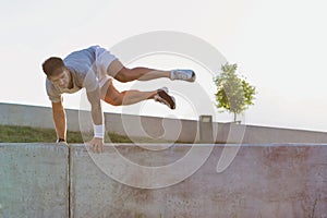 Young attractive man jumping on wall