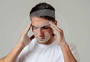 Young attractive man in pain with headache suffering migraines