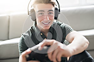 Young attractive man playing video games in the livingroom