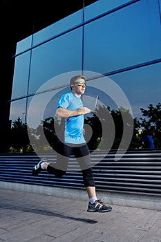 Young attractive man running and training on urban street background on summer workout in sport practice