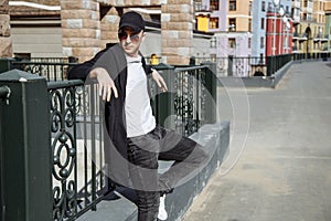 Young attractive man in sunglasses in urban background.