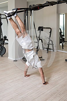 Young Attractive Man Training With Trx Fitness Straps