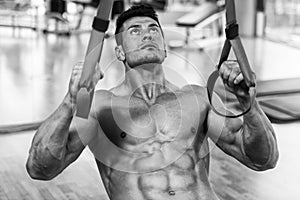 Young Attractive Man Training With Trx Fitness Straps