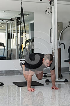 Young Attractive Man Training With Trx Fitness Straps