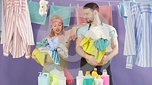 Young attractive man and woman having break while doing household chores