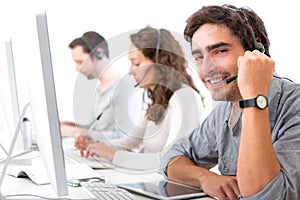 Young attractive man working in a call center