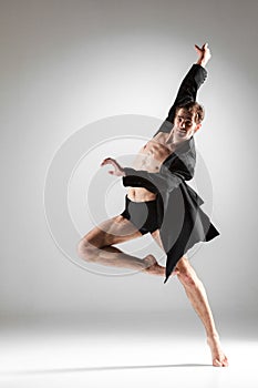 The young attractive modern ballet dancer on white