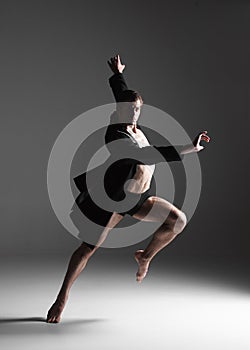 The young attractive modern ballet dancer on white