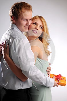 The young attractive pair in love with gift