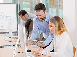 Young attractive people taking a training course with formator