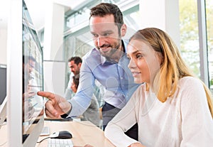 Young attractive people taking a training course with formator