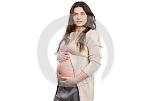 Young attractive pregnant woman holding her belly