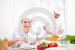 Young attractive professional chef cooking in his kitchen