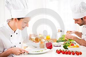 Young attractive professional chef cooking in his kitchen