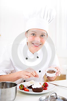 Young attractive professional chef cooking in his kitchen