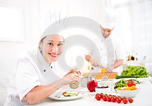 Young attractive professional chef cooking in his kitchen