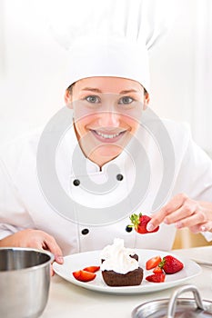 Young attractive professional chef cooking in his kitchen