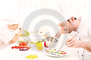 Young attractive professional chef cooking in his kitchen