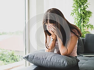 Young attractive and sad woman sitting depressed at home sofa couch feeling anxious and frustrated suffering depression problem,