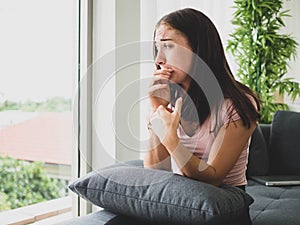 Young attractive and sad woman sitting depressed at home sofa couch feeling anxious and frustrated suffering depression problem,